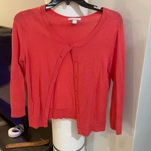 Really pretty pink sweater. The buttons are a clear pink too